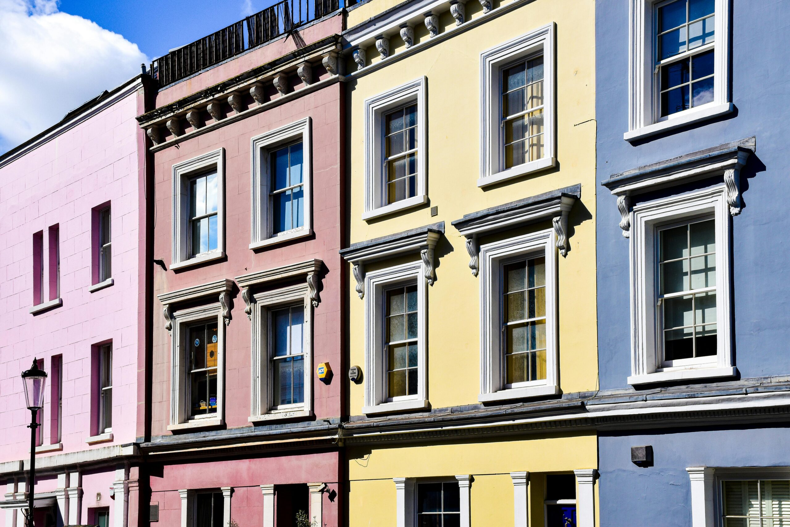 Vibrant, multi-colored houses in Notting Hill, London, showcasing urban charm.