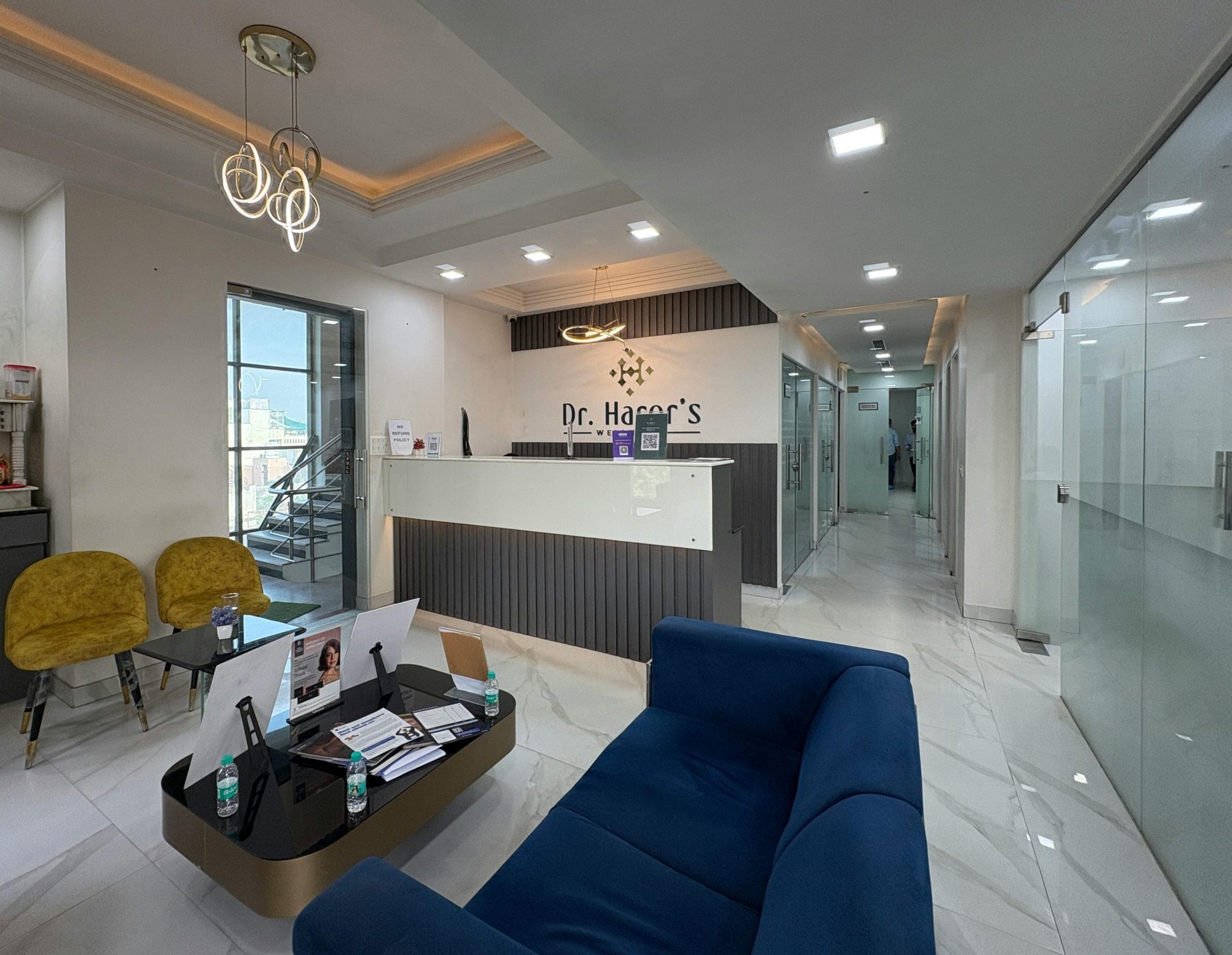 Elegant clinic reception area with sleek design and modern furnishings, located in New Delhi.