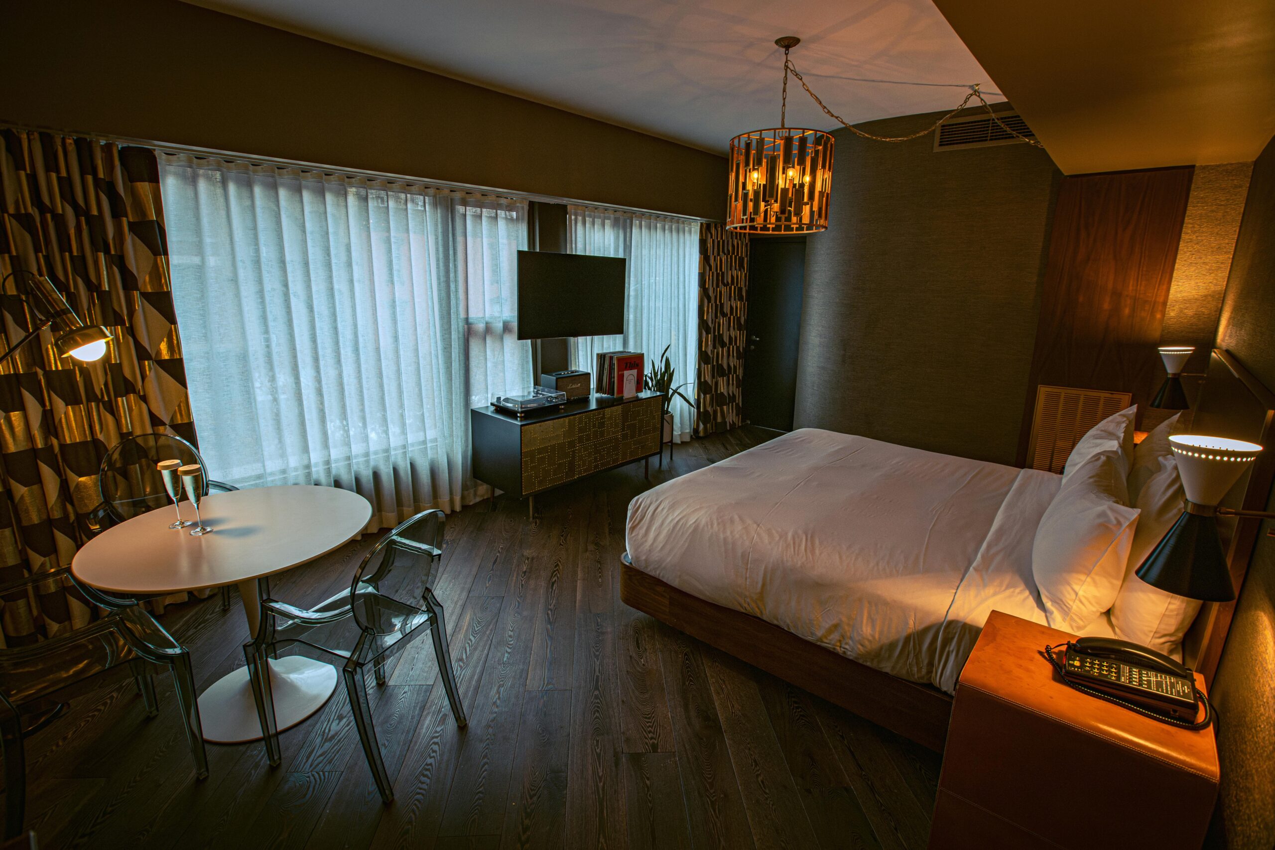 Cozy hotel room in New York City featuring a chic modern design with a record player and stylish furniture.